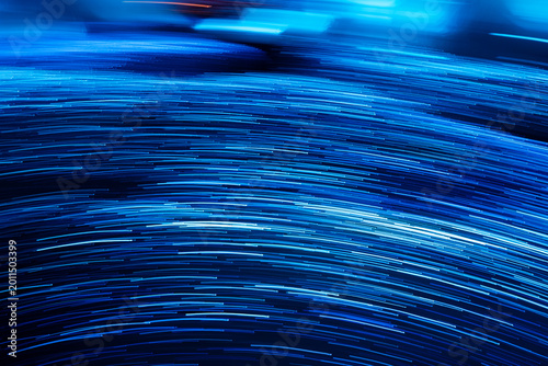 Foto Abstract blue neon light trails and glowing motion blur waves with futuristic d