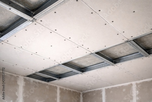 Suspended ceiling made of drywall fixed by screws on metal framework with copy space
