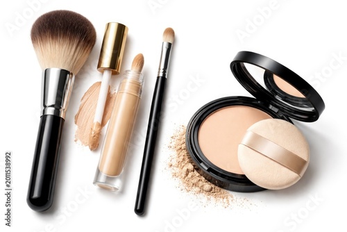White background featuring isolated makeup brushes alongside concealer and powder