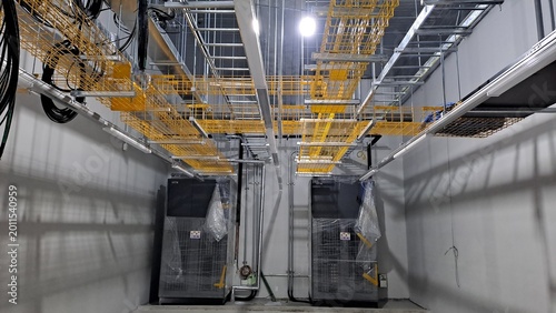 Photography yellow mesh cable trays and infrastructure in a data center meet me room mmr und