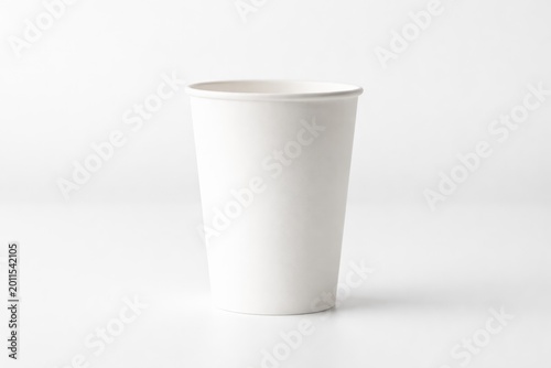 Single disposable cup in white color with front facing orientation on white base