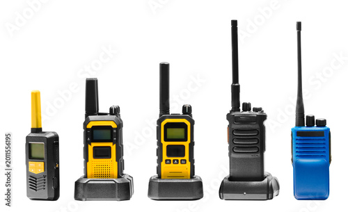 Five radios stand against white background. black, yellow, and blue. Some are equipped with antennas, while others are compact. Each model features different functions, such as buttons or screens.