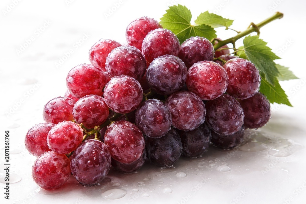 Naklejka premium Ripe red grapes coated in natural fruit wax set on white backdrop