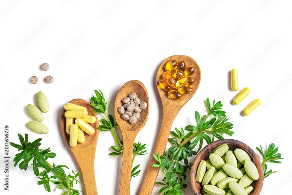 Fototapeta premium Natural vitamins, plant based supplements and green leaves