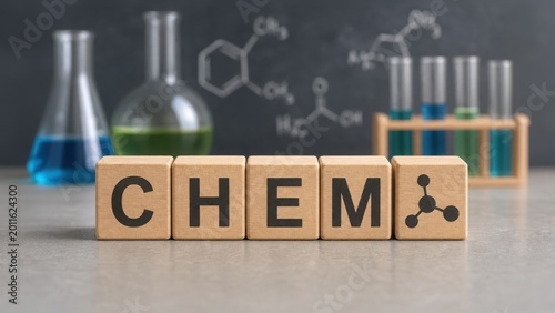 Wooden blocks spell CHEM in a science lab setting with beakers, test tubes, and chemical formulas on a blackboard.
