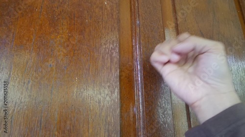 A guest person knocking the door for visiting a friend