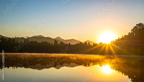 Golden Sunrise Reflecting Over Calm Mountain Lake and Forest