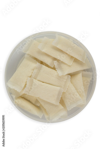 nicotine pouch snus white portion small bags in plastic container top view on white background minimalist studio shot with copy space for banner design concept of tobacco industry, addiction