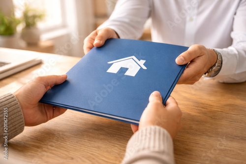 Handing over a property contract in a modern office setting