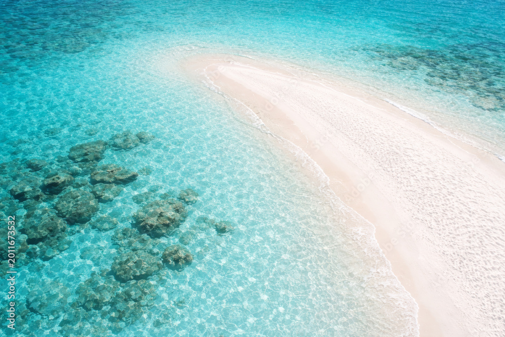 Fototapeta premium Aerial view of tranquil blue ocean and sandy beach