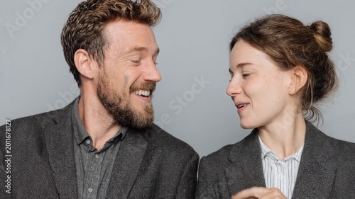 Happy business colleagues playfully pointing fingers, laughing, and looking at each other
