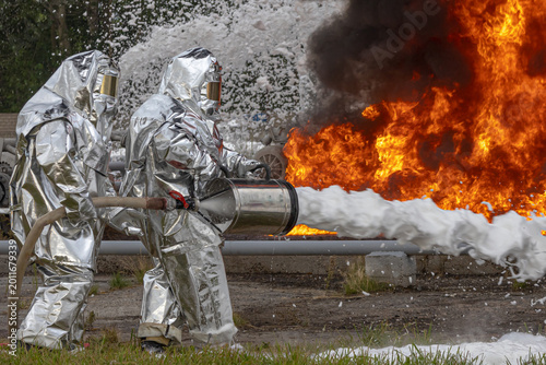 Firefighters use a foam generator to supply foam to extinguish the fire. A fire at the plant caused by the ignition of an oil product. Firefighters extinguish a fire at an oil refinery.