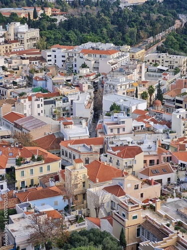 Aerial view of Athens, Greece with iconic white houses and urban cityscape under sunlight