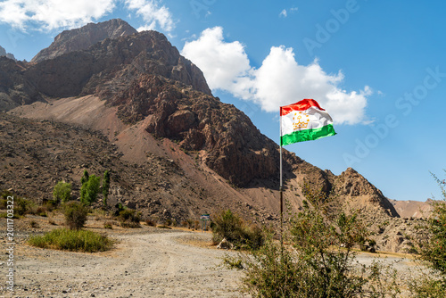 Tajikistan national flag for independence day. Tajikistan flag waving in beautiful scenery.