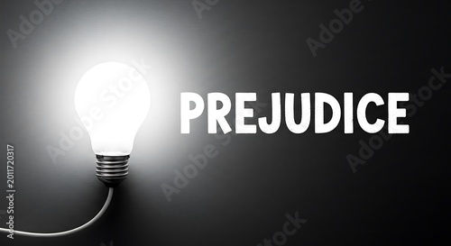 Lightbulb illuminating the word prejudice on dark background