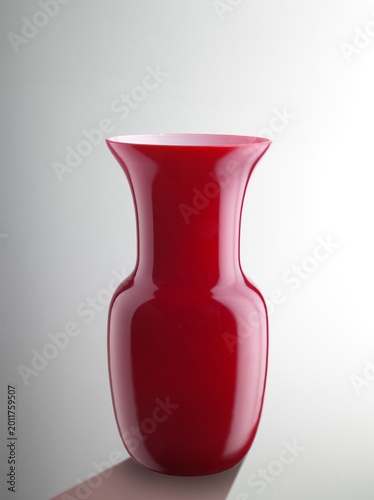 Still life of a red glass vase, on a neutral background