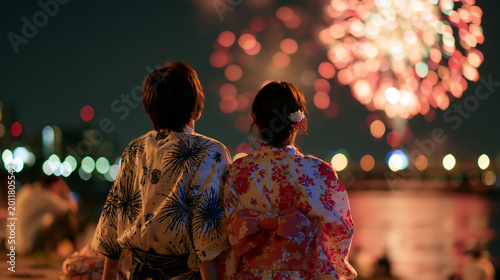 Japanese Couple in Yukata Watching Fireworks Display Together at Summer Night Festival Romantic Scene