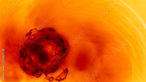Dark red ink diffusion in bright liquid creating abstract organic motion and soft gradients