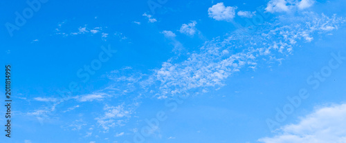 Clear blue sky filled with small white scattered clouds.