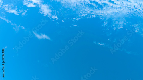 Fotografie Clear bright blue sky with sparse white clouds panorama.