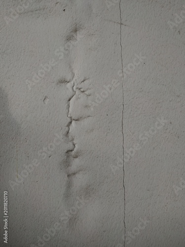 Minimalist cracked concrete wall texture with rough plaster surface and subtle damaged details, abstract grunge background with aged urban atmosphere.