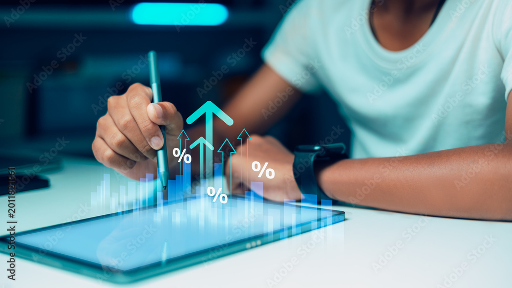 © Thawatchai Images - Digital Financial Growth and Investment Strategy Concept with Growth Graph on Tablet
