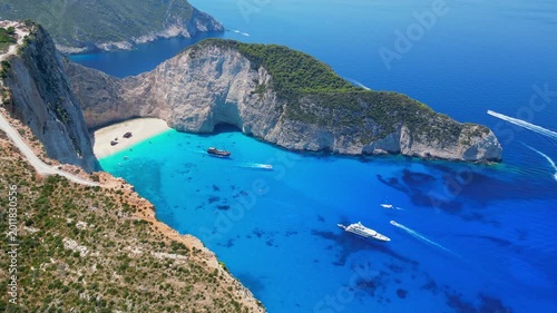 Spectacular view of the iconic Shipwreck beach in Navagio Bay, Zakynthos. Famous rusted boat on white sand surrounded by massive limestone cliffs and turquoise Ionian Sea water.