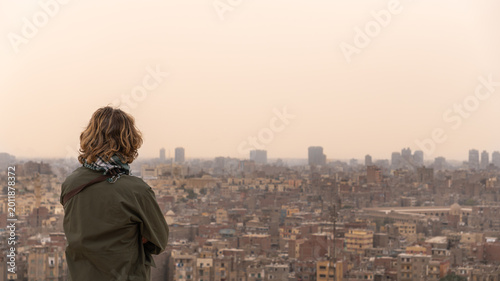 Photos Tourist observing the expansive urban settlement, experiencing wanderlust and co