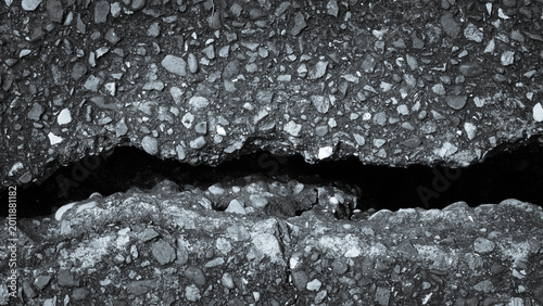 Deep asphalt fissures and a dark abyss representing earthquake damage and internal mental fractures.