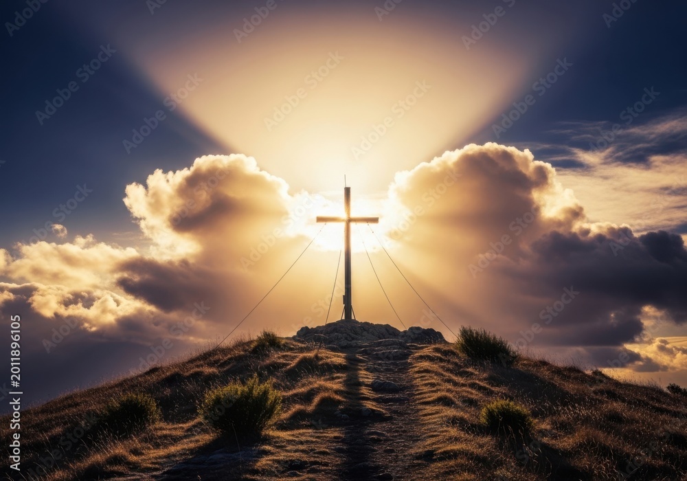 Obraz premium Cross on a rocky hilltop with dramatic sky and clouds
