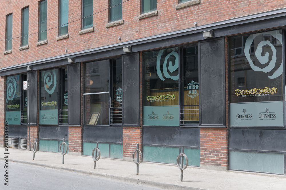 Naklejka premium exterior building and signage in window at Grace O’Malley’s, an Irish pub, located at the corner of 14 Duncan St and Pearl St, Toronto
