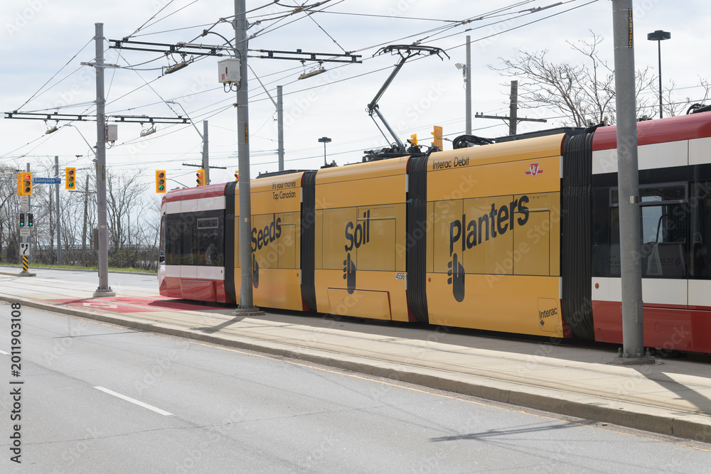 Fototapeta premium Interac debit service advertising wrap on TTC trolley, The Queensway, Toronto