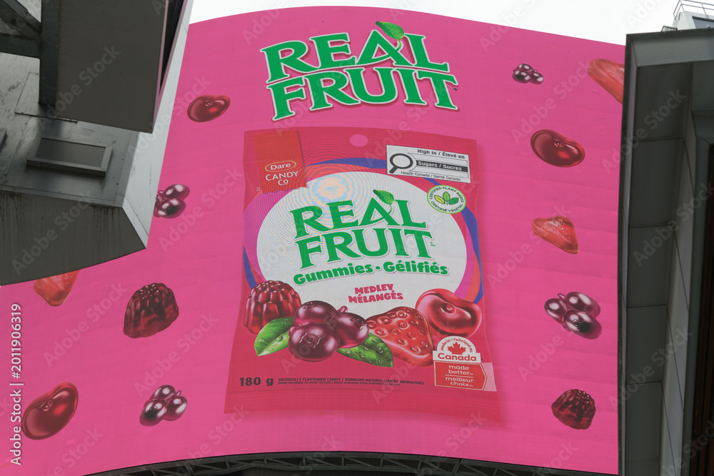 Fototapeta premium digital billboard featuring ad for RealFruit Gummies by Dare Foods Limited at Sankofa Square, Toronto