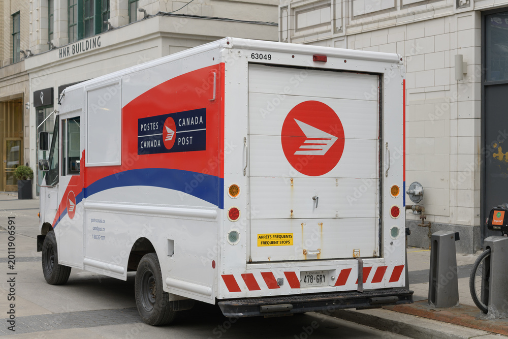 Fototapeta premium Canada Post delivery vehicle parked on Dundas Square, near The Hermant Building (designed by Benjamin Brown, 1929), Toronto
