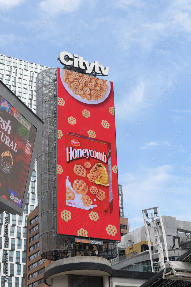 Obraz premium Citytv sign a top digital billboard at Sankofa Square featuring ad for Honeycomb cereal, Toronto