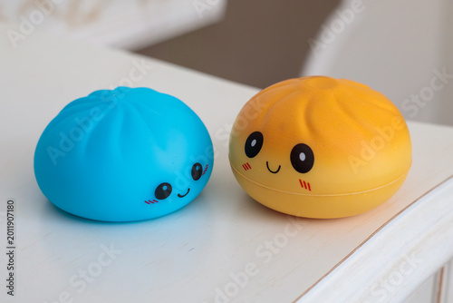 Cuadro en lienzo blue and yellow kawaii squishy dumpling toys with cute smiley faces and rosy che
