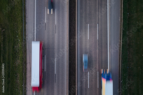 Overhead view of a highway with moving vehicles in the evening.