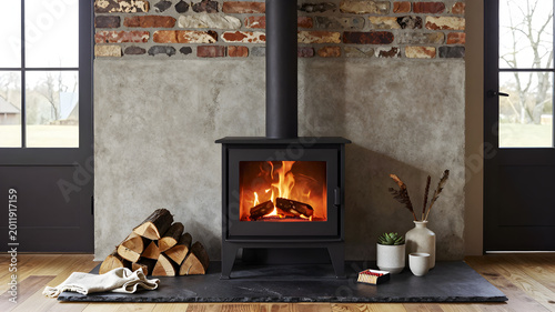 Cozy living room with black wood burning stove and slate hearth surrounded by fireplace essentials