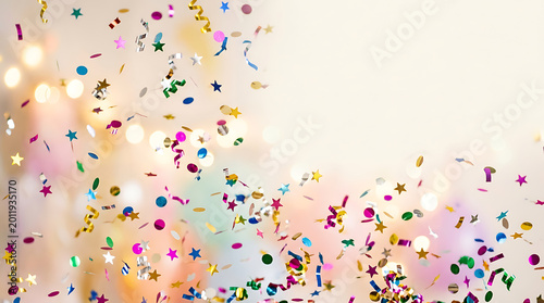 Vibrant abstract confetti and streamers falling in gold and pink