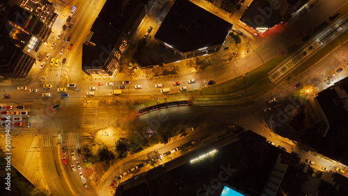Tableau sur toile Night aerial view of a busy city intersection with cars, buses and a tram weavin