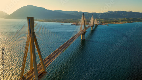 Tableau sur toile Rio–antirrio bridge spans the blue gulf of corinth at golden hour, cable-stayed