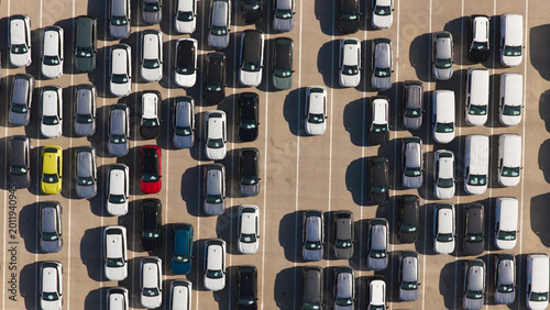 Tableau sur toile Rows of newly manufactured passenger vehicles and vans parked diagonally on a va