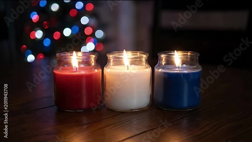 Atmospheric 4K Slow Motion of Three Red White and Blue Patriotic Candles Flickering on a Wooden Table with Festive Bokeh Lights