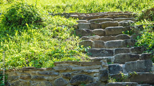 Fotografie Old stone stairs on a grassy hillside