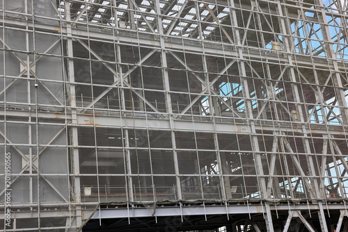 Covered facade of a reconstruction building, Scaffolding with safety nets during renovation building.