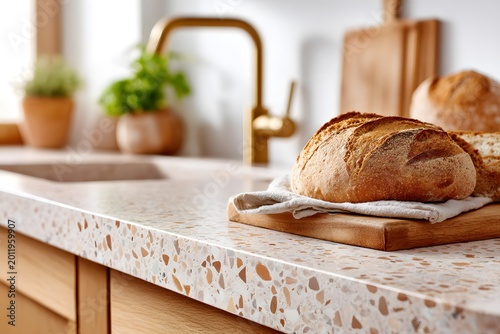 Countertop features terrazzo design with wooden board and bread placed on it
