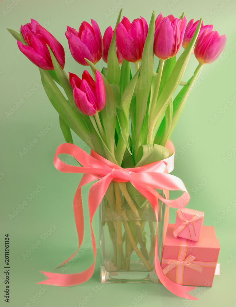 Fototapeta premium Pink tulip bouquet with ribbon and copy space, Mother’s Day appreciation and Women’s Day theme