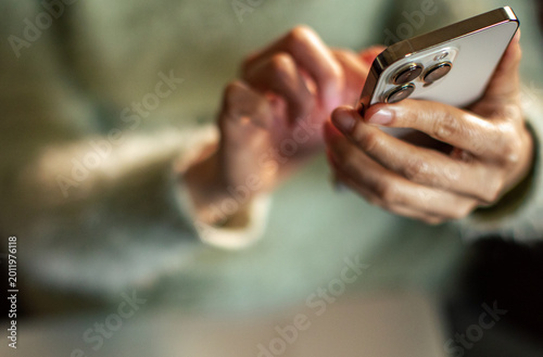 Adult hands texting on smartphone at home