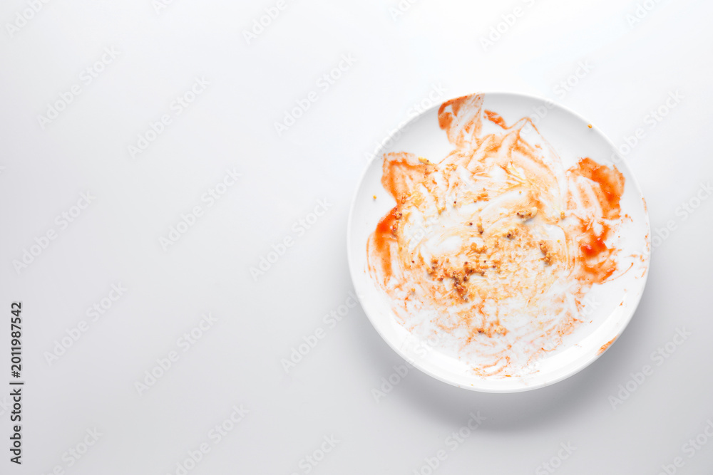 Obraz premium One dirty plate on white background, top view. Space for text