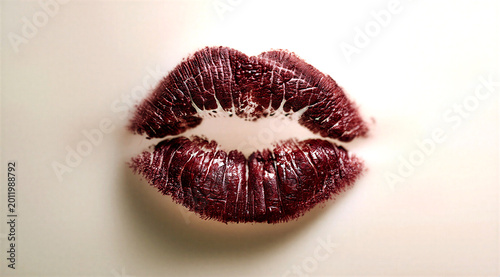 Closeup view of sensuous red lips with dark maroon lipstick texture and natural lines